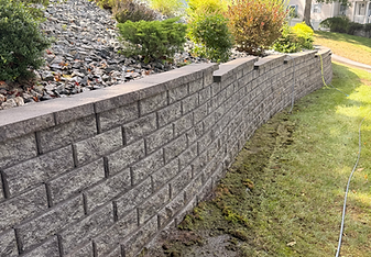 Clean stone retaining wall and walkway after pressure washing