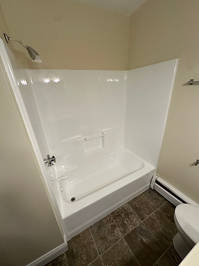 Reglazed white tub and shower surround