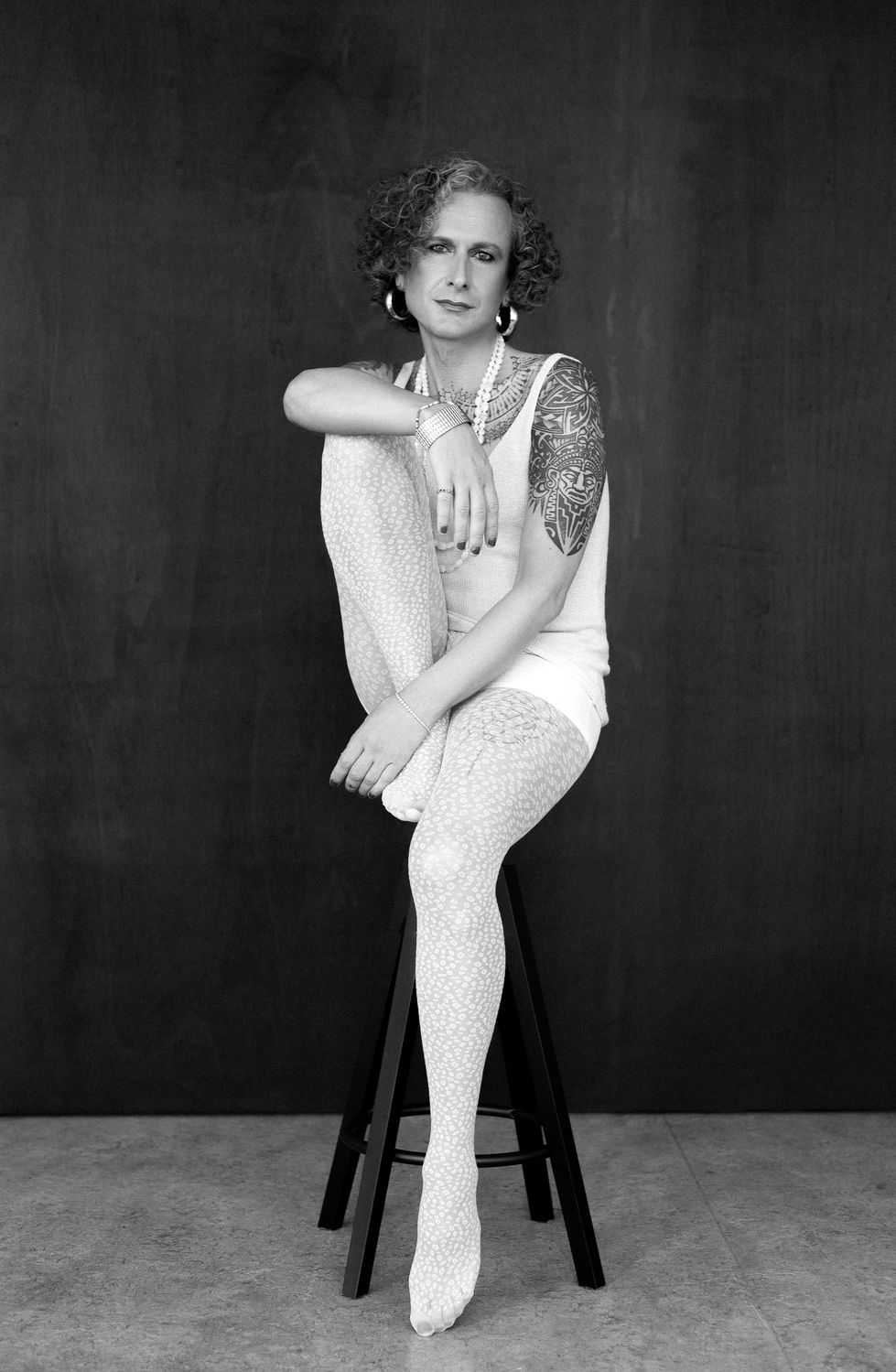Minimalist black and white pose, trans female model with statuesque presence