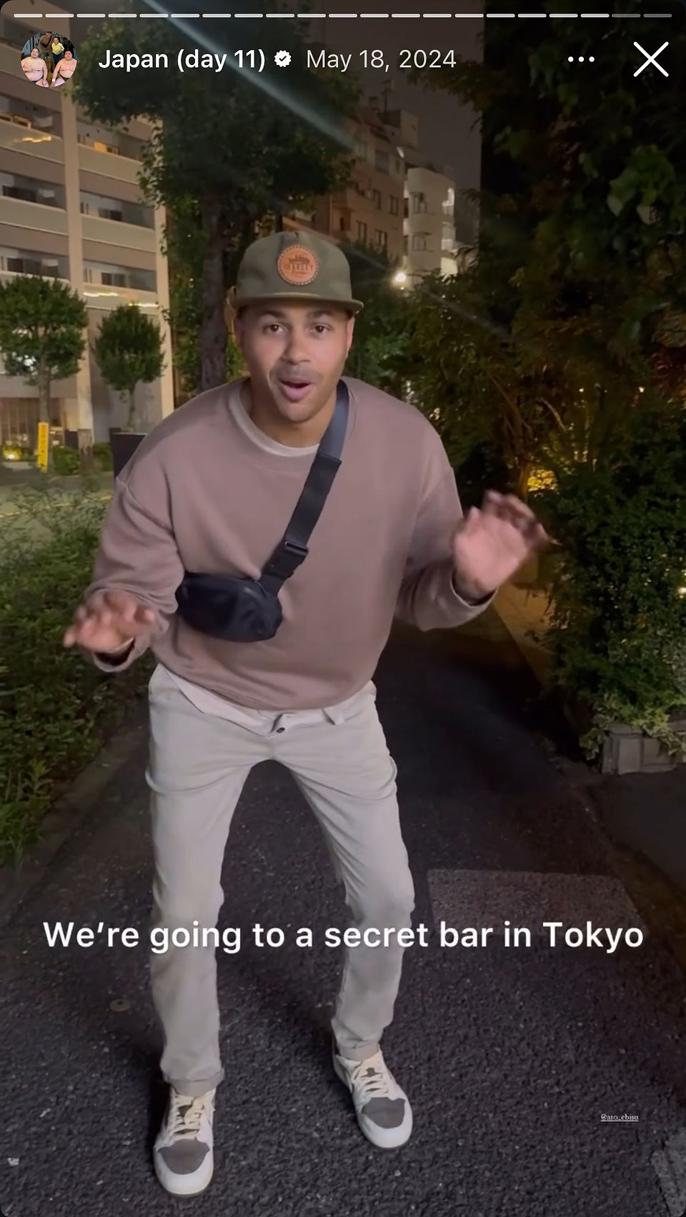 excited man crouched down talking about a secret bar in tokyo