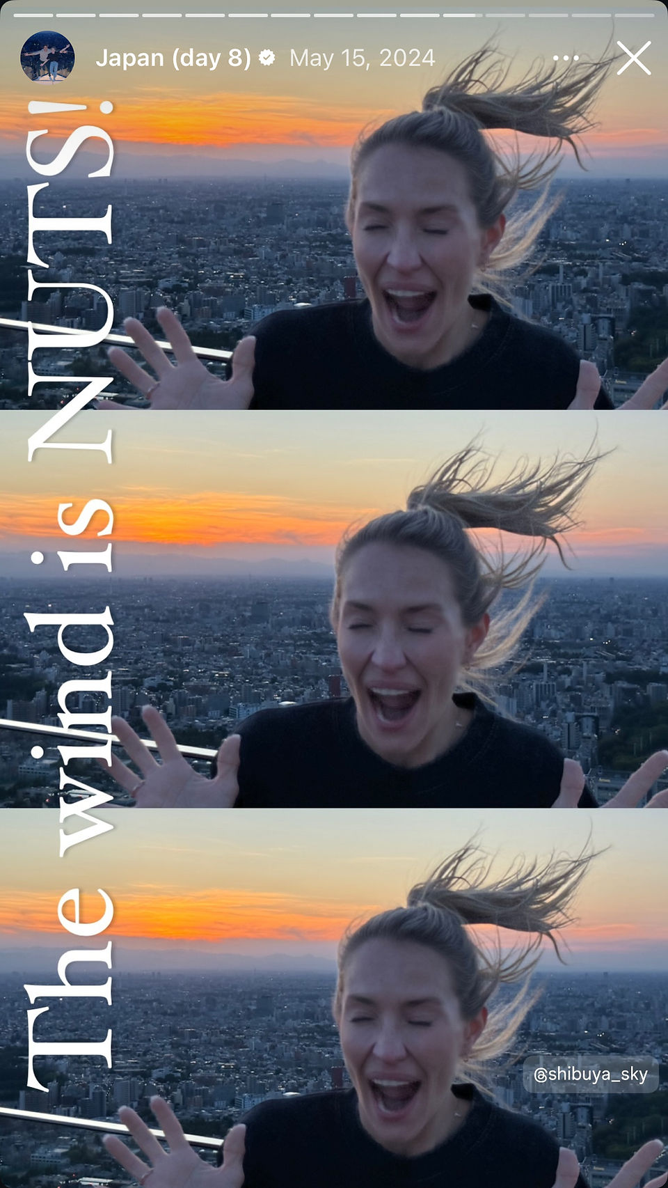 woman with exhilarated look on her face on top of tall building