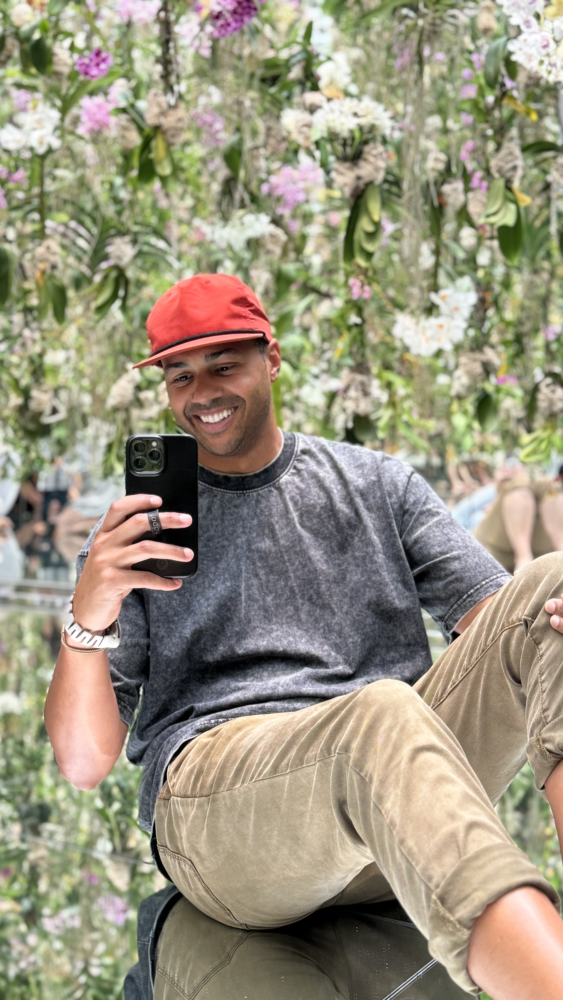 man posing for photo in floral art exhibit