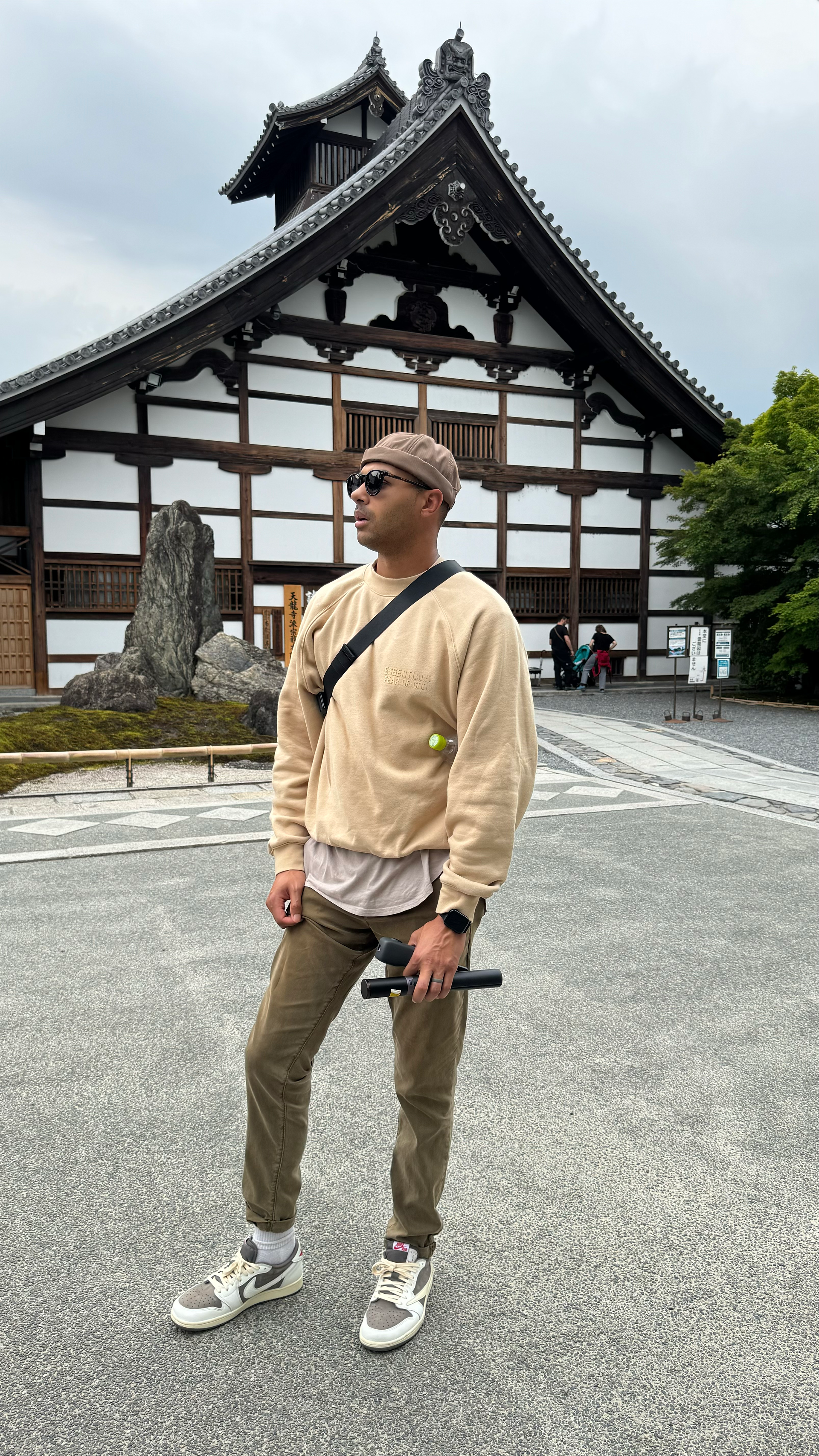 man posed for picture in front of Tenryu-ji Temple in Kyoto, japan