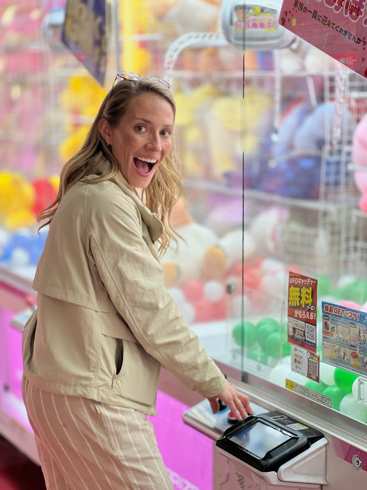 woman excited to play japanese arcade game in osaka, japan
