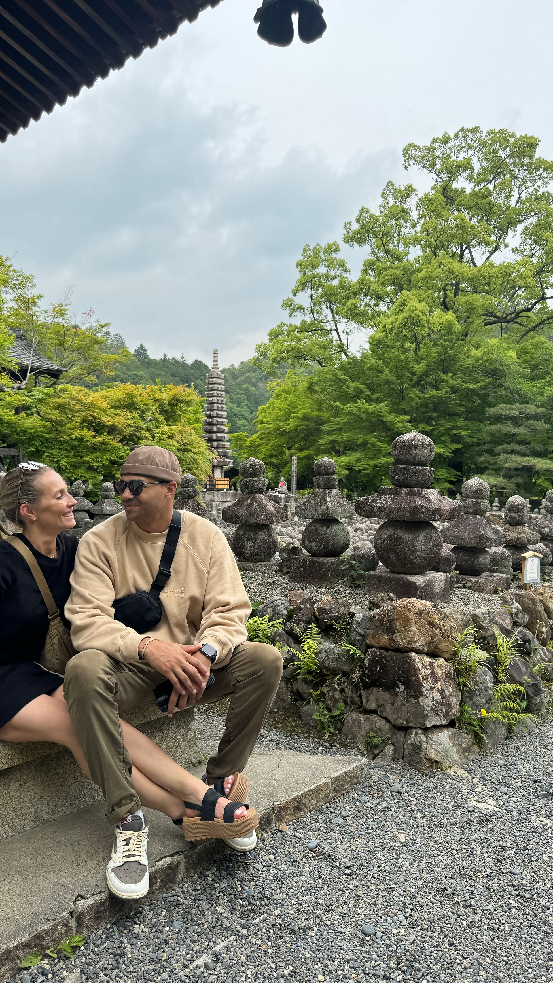 couple posing in front of Adashino Nenbutsuji Temple in Kyoto japan
