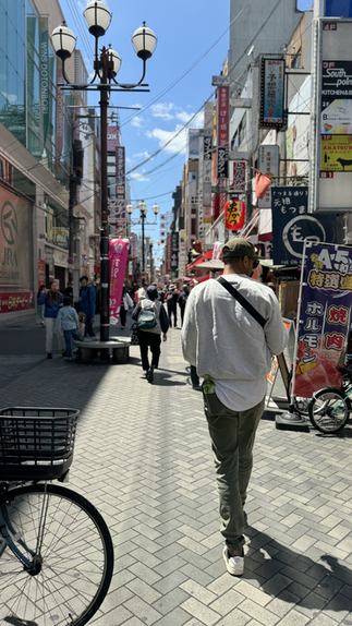 man standing on street of Dontonburi in Osaka japan