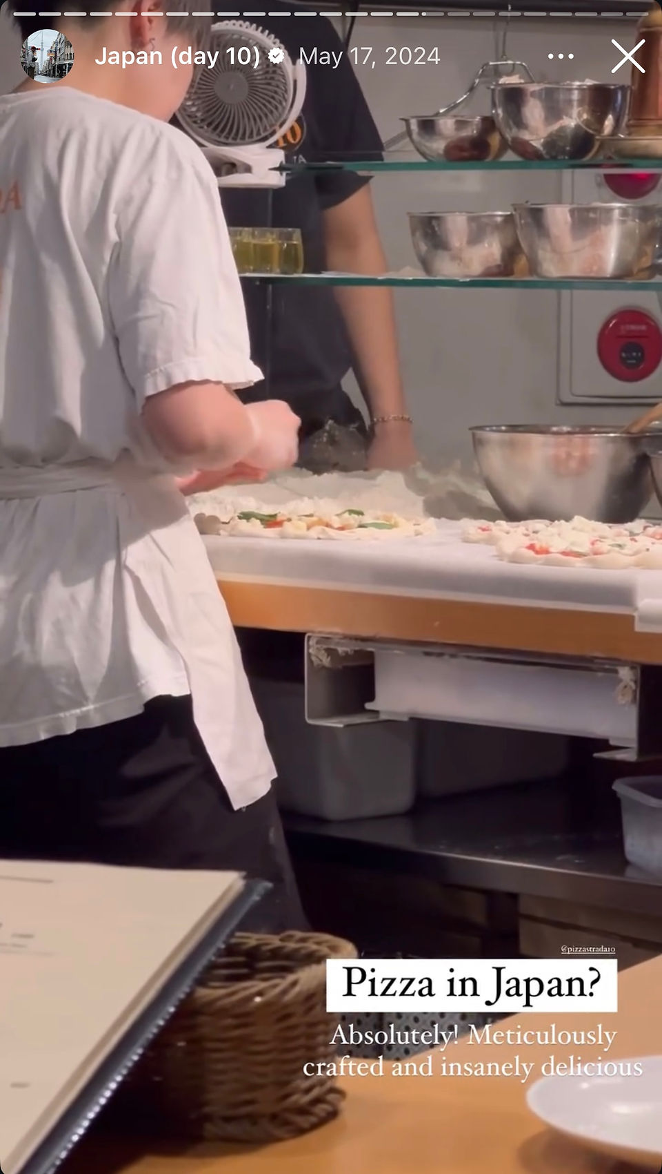 chef prepares pizza in japanese kitchen