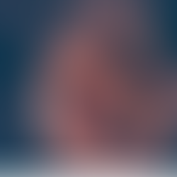 A spoon holds spices like cinnamon and cardamom over a glass jar. Warm tones create a cozy, aromatic mood against a blurred background.