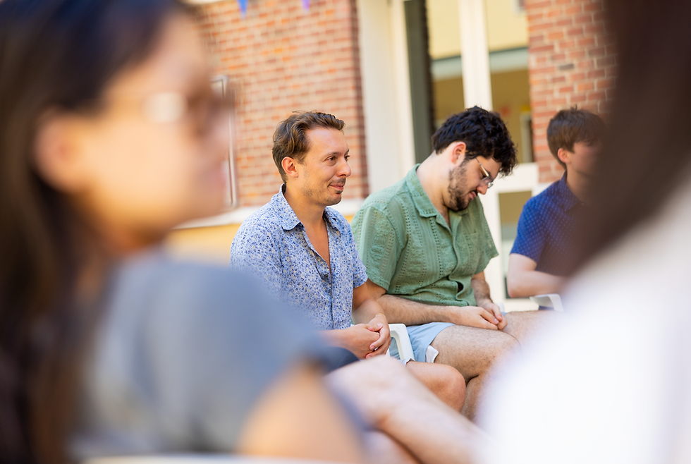Piano teacher in conversation with a group of adult music students