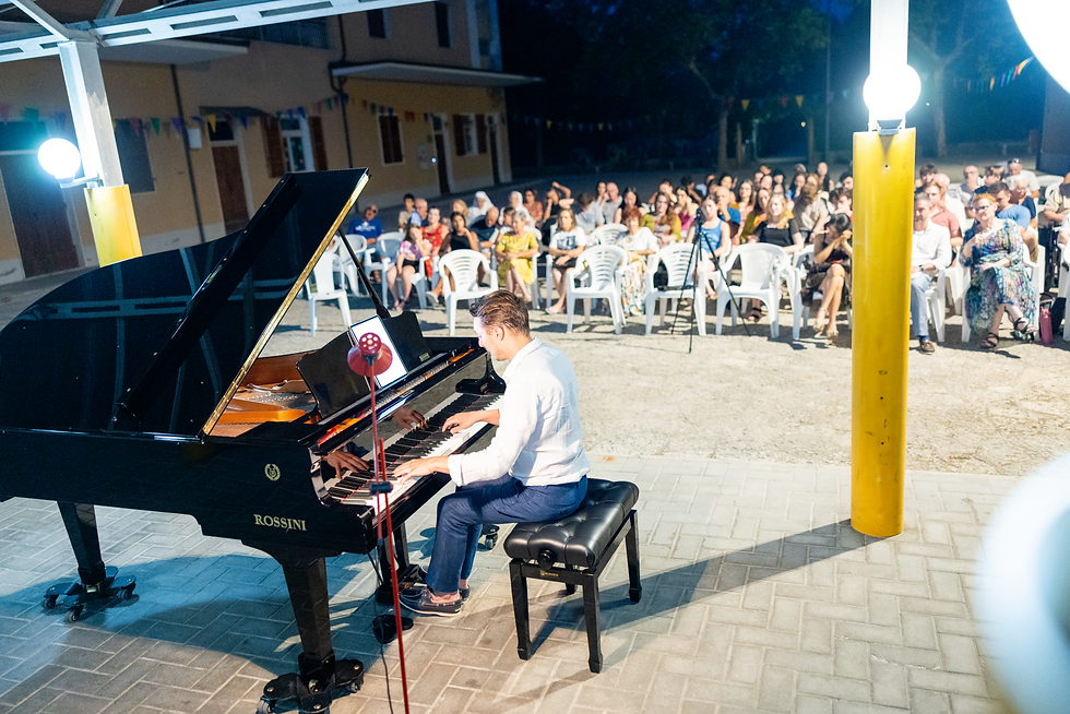 Piano teacher performing on stage in front of a live audience