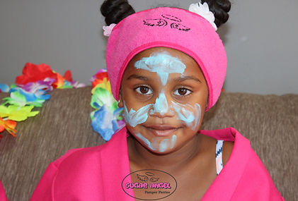 Little girl with face mask and pink spa gown at a Sugar Angel Pamper Party