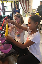 Girls having fun stretching slime at a sugar angel pamper party