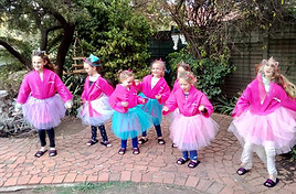 Pretty little girls dancing with pink tutus at a pamper party