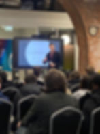 Rio Leach-Aslam on stage delivering a keynote talk on execution and getting results to a business audience.