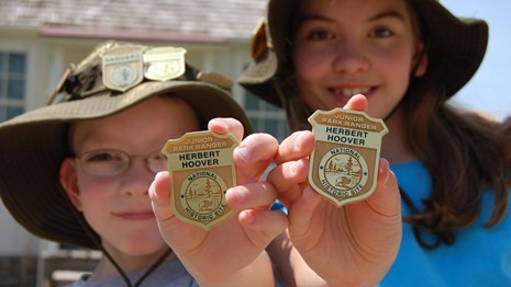 children-holding-junior-ranger-badges-military-wild-child