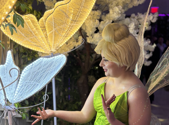 Tinker Bell poses for a photo at a child's birthday party
