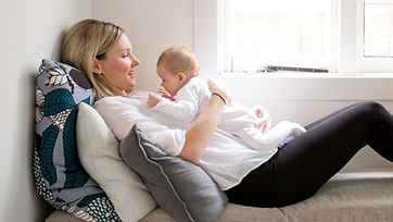 Parent reclining with baby positioned for tummy time