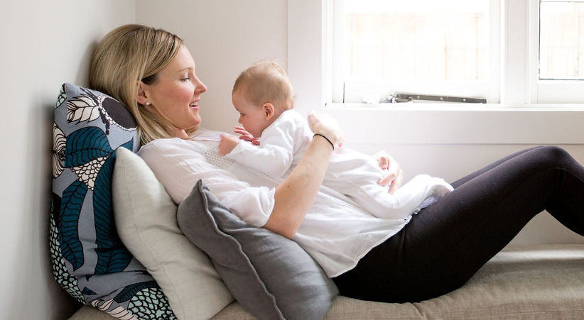 Newborn baby doing tummy time on parents chest