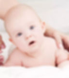Baby with torticollis laying in bed