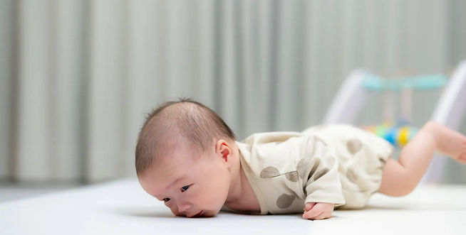 2 month old baby lifting head briefly during tummy time