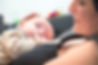 Baby with neck tightness laying on the parent's chest, parent looking at the baby's head shape from top