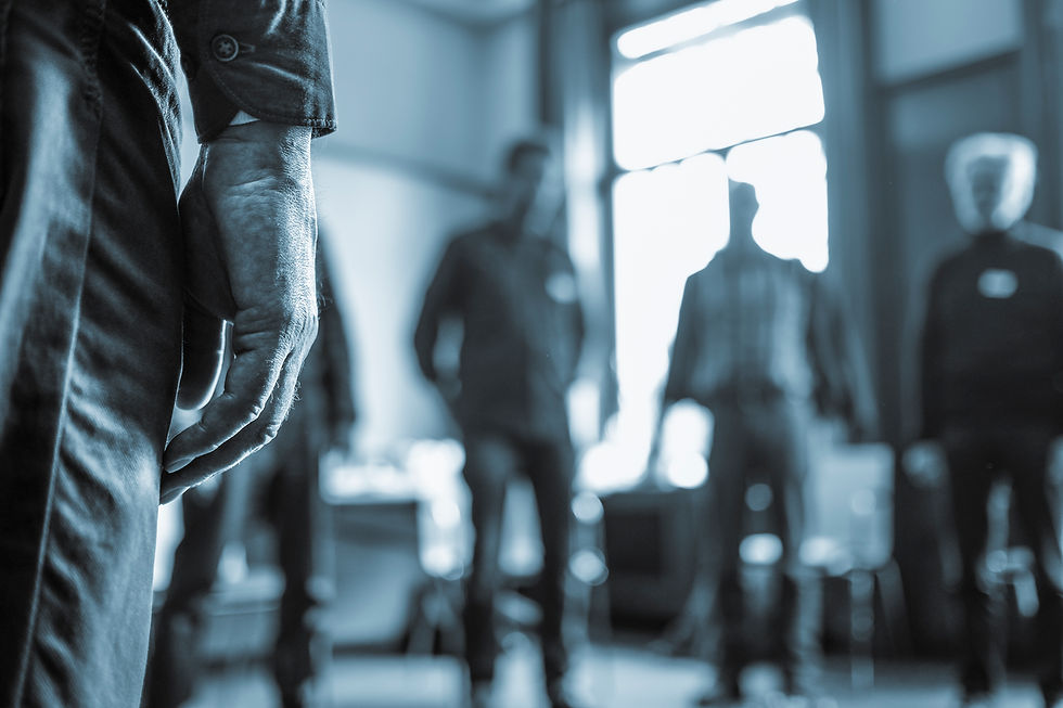 Männer im Kreis beim Bremer Männertag, eine Hand im Vordergrund, ruhige Atmosphäre im Raum