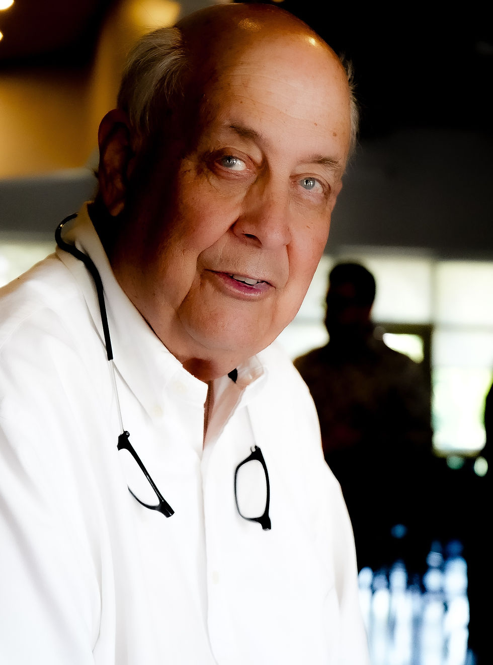 Older man in white shirt with glasses