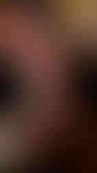 Two hands holding a Carling black label can. One is at the base while the other one is cracking the tab to open it, there is a spray of beer coming out of the can. The lighting feels bright on the can. Taken in Bristol Bar The Milk Thistle 