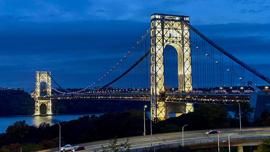 The George Washington Bridge towers lit up at night
