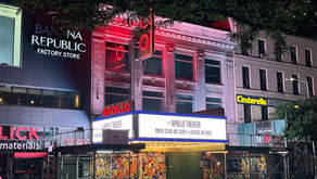 The Apollo Theater's renovated marquee and sign shine brightly at night