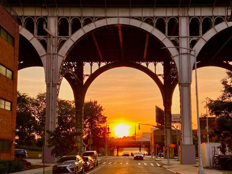 Sun setting between arches of Riverside Drive Viaduct during Manhattanhenge