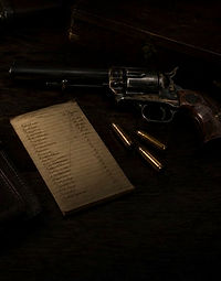 Revolver with bullets and paperwork for downsizing a gun collection and consigning to gun auctions usa