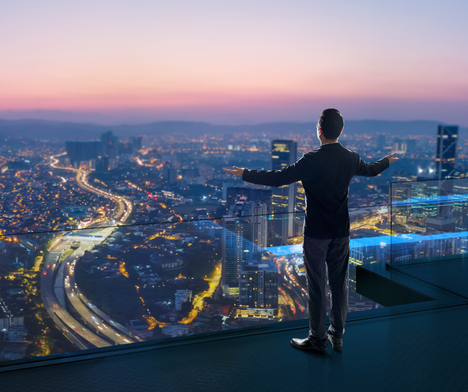 travel business development A man staring the city view from the roof deck.