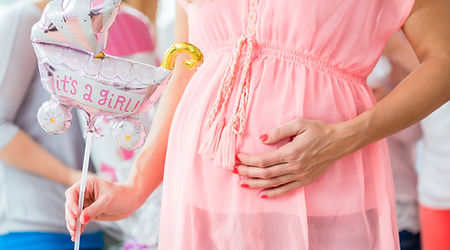 Baunty Channel Creations: Radiant mother-to-be surrounded by blooming flowers, capturing the beauty and joy of an extended maternity photography session.
