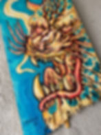 Painting of an orange jaguar on a skateboard