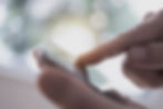 Picture of hand holding a smartphone and scrolling on a blank page