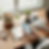 Woman holds phone with wellness app at desk. Salad boxes, water, headphones, shoes, plant, and open notebook labeled Daily Gratitude visible.