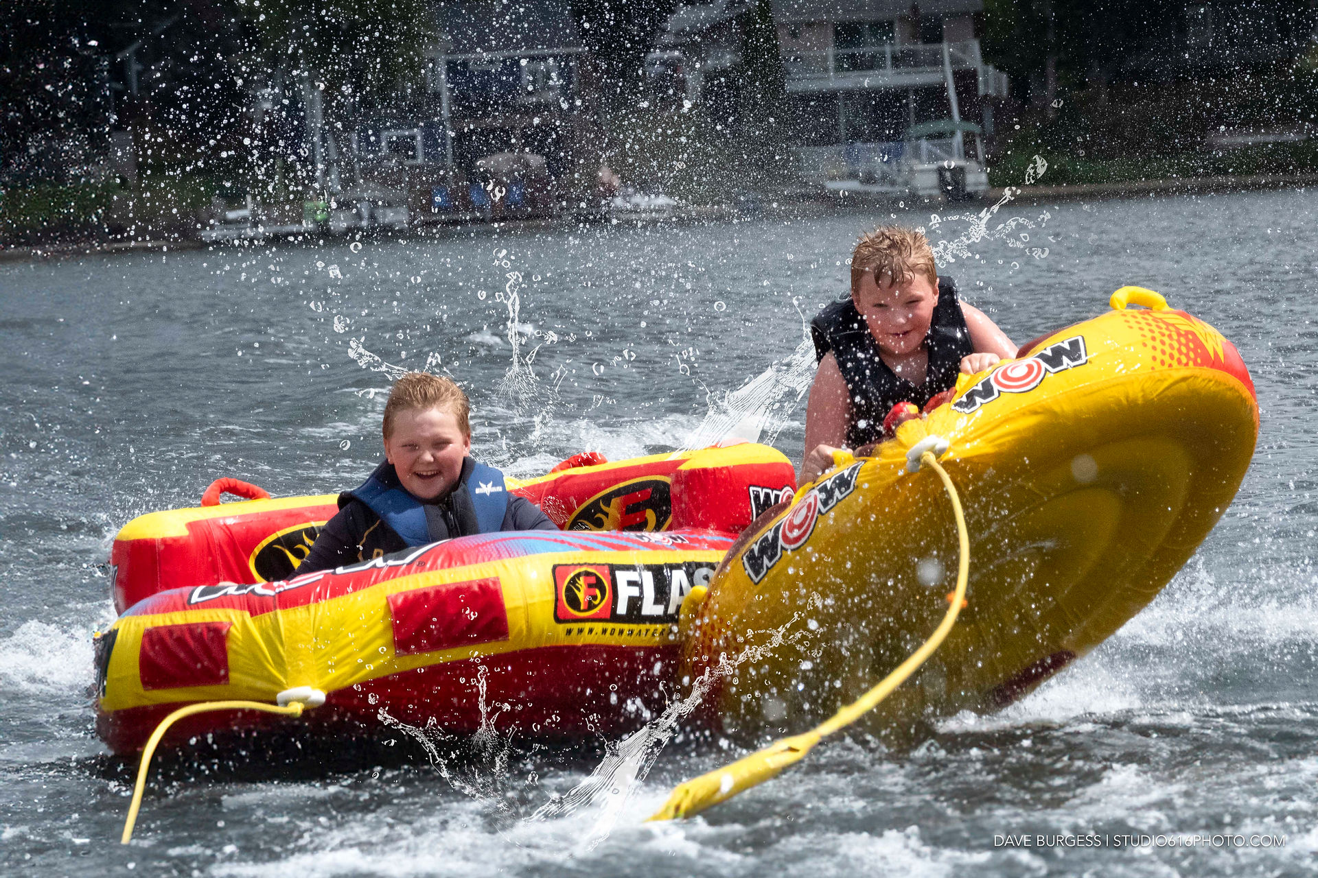 two boys being towed on tubes