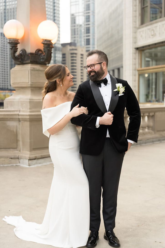 Bride and groom embracing in front of Art Institute