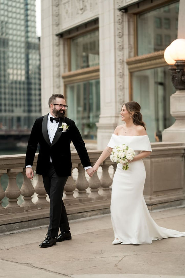 Bride and groom walking hand in hand outside of Art Institute