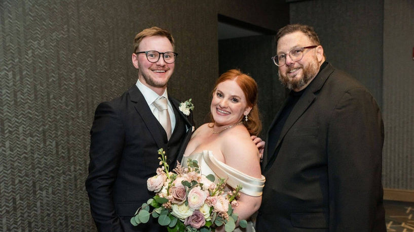 Bride and groom with wedding officiant, Frank.