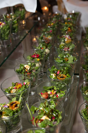 Colorful appetizers arranged in clear glasses, ready for guests.