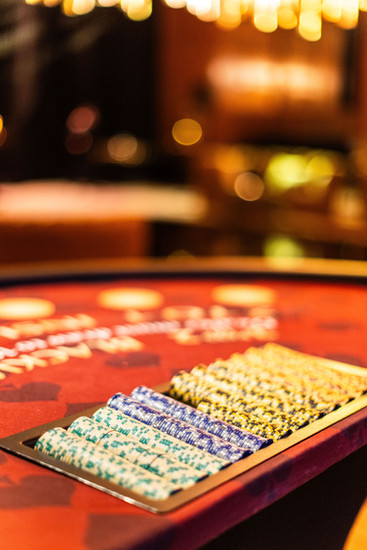 Close-up of a casino chip tray with stacked chips on a red felt blackjack table at a Chicago casino party event