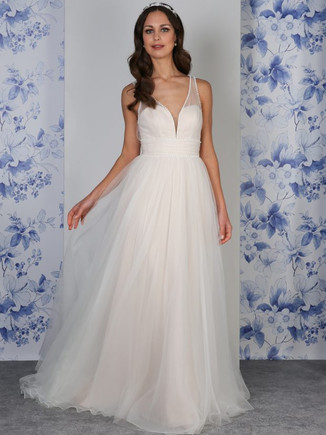 The soft, romantic Penny gown features smooth draping satin for a luxurious lining, with an overlay of floaty organza and tulle. Delicate tulle pleats create a gathered, wide sash to pull in the waistline. The gathers continue over the sheer illusuion straps, while the sweetheart bodice is fully lined with boning and padded cups for support. A beautifully simple, flattering shape give this gown a timless look, lined with a subtle rows of dainty pearls for a perfect, elegant finish.