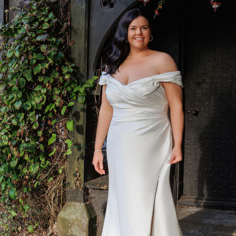 Fit and flare wedding dress with split and stunning lace train, by Island Bridal.