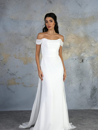 This off the shoulder dress has a beautifully draped neckline, which flows into the flattering floor length chiffon skirt. The soft train floats effortlessly from the waist to add softness to the look.