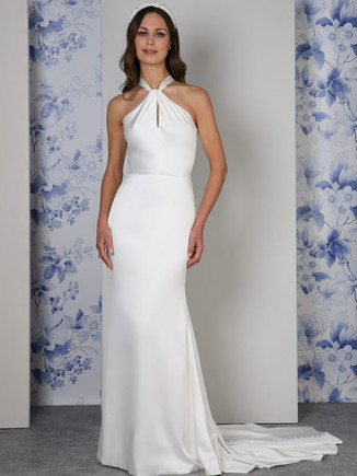 The simple beauty of the Capri dress is in its modern, pared-back design with its slinky satin and clean lines. The dress is fully lined in our softest satin for a luxurious feel on the body. A clever twist of fabric at the neck reveals a subtle keyhole neckline as you move. The statement halterneck bow on the back is revealed as you turn, for an elegant dress full of personality.