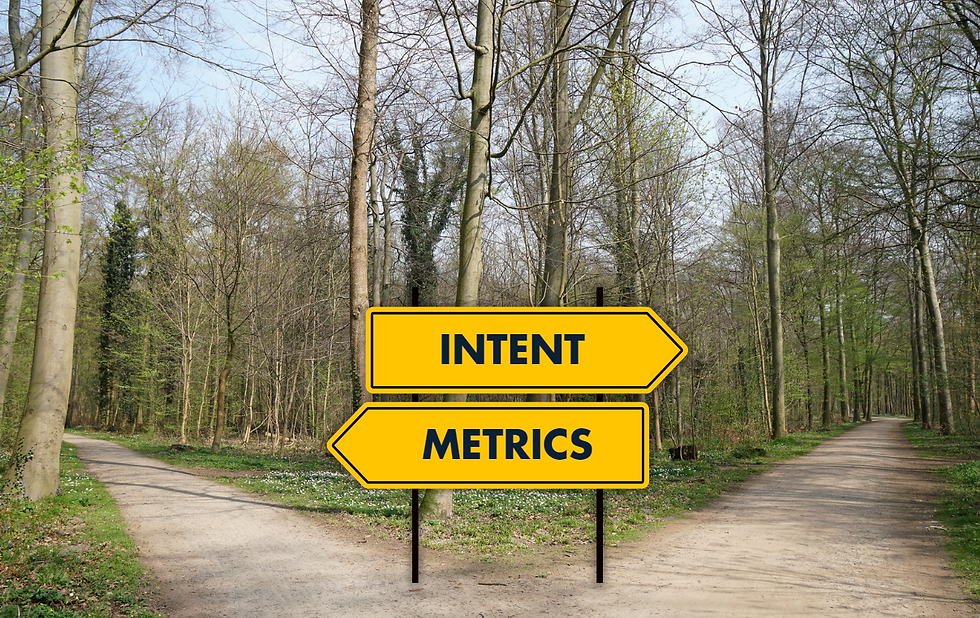 A road sign showing two paths: one labeled “Metrics” and the other “Intent.”