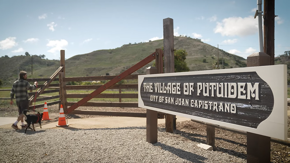 Todd Perry walks through the entrance to the Village of Putuidem in San Juan Capistrano. The village is a 1.5-acre sacred site and cultural park, reconstructed on a portion of ancestral Putuidem in San Juan Capistrano’s northwest open space. Screenshot from from “On the Backs of our Ancestors,” courtesy of Todd Perry