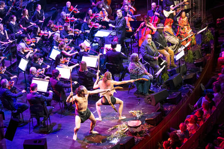 a performance photo of Kutcha Edwards and the Sydney Symphony Orchestra at Sydney Opera House